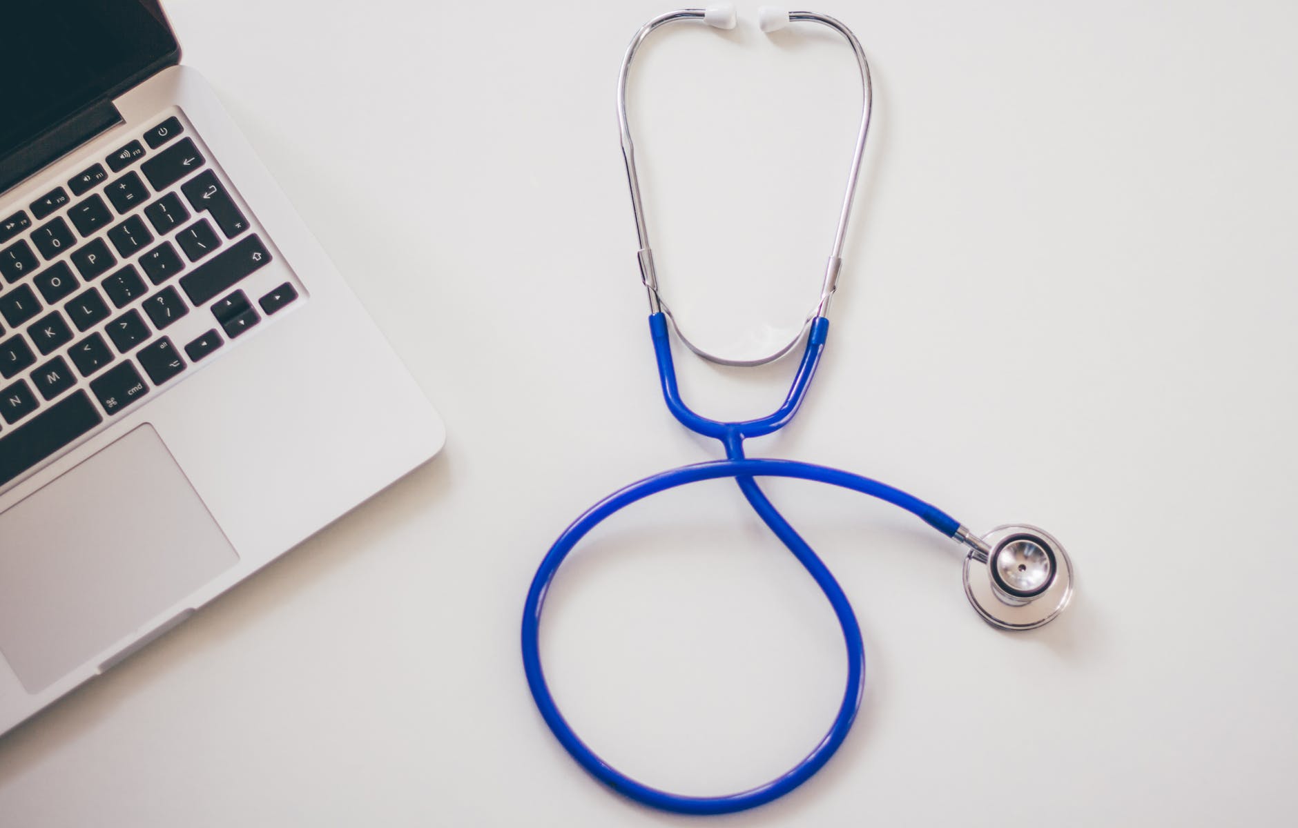 Image of a stethoscope and laptop keyboard.