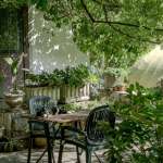 beautiful outdoor garden with chairs, table and plants